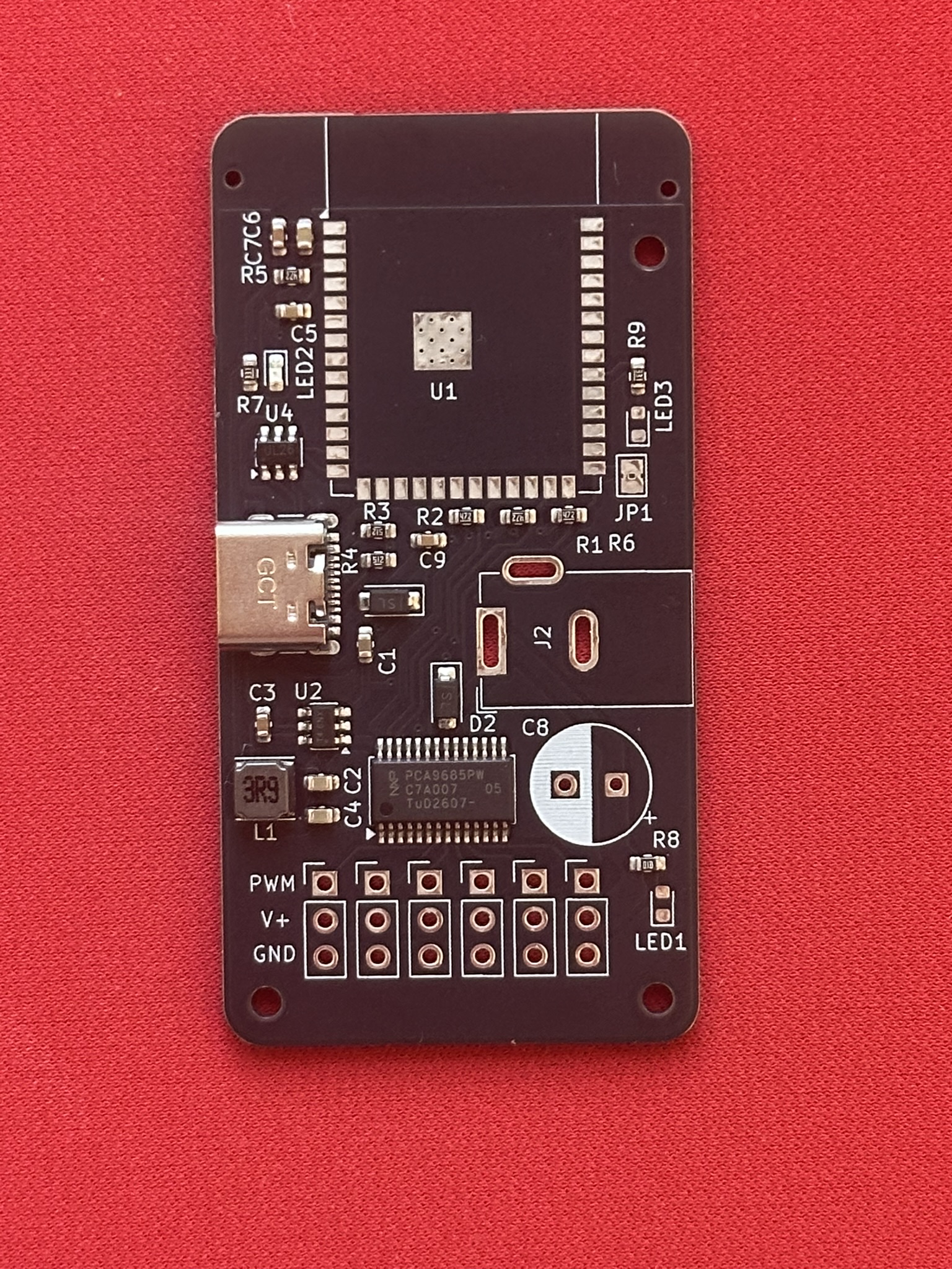 Manufactured PCB held in hand after surface-mount assembly and component verification